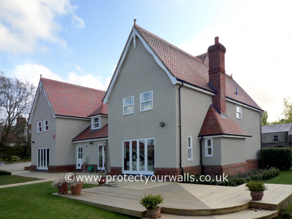 Freshly rendered house, Essex - front view with decking.