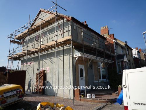 Preparing a house for rendering, side view.
