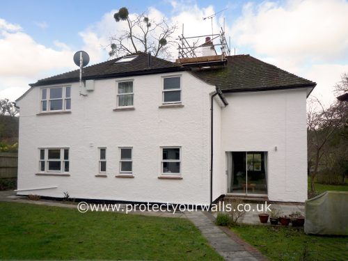 Freshly rendered cottage, side view.