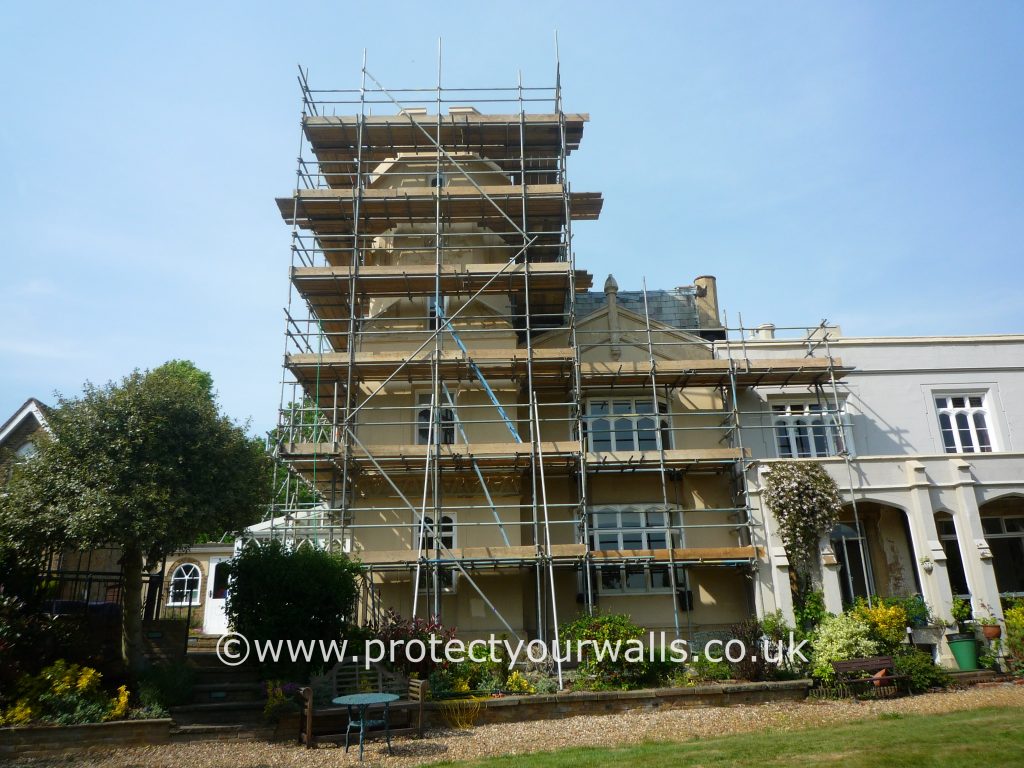 A turret covered in scaffolding during rendering.