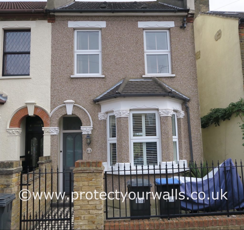 Rendering over pebbledash on a semi-detached house.